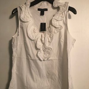 A white sleeveless top with a ruffle collar.